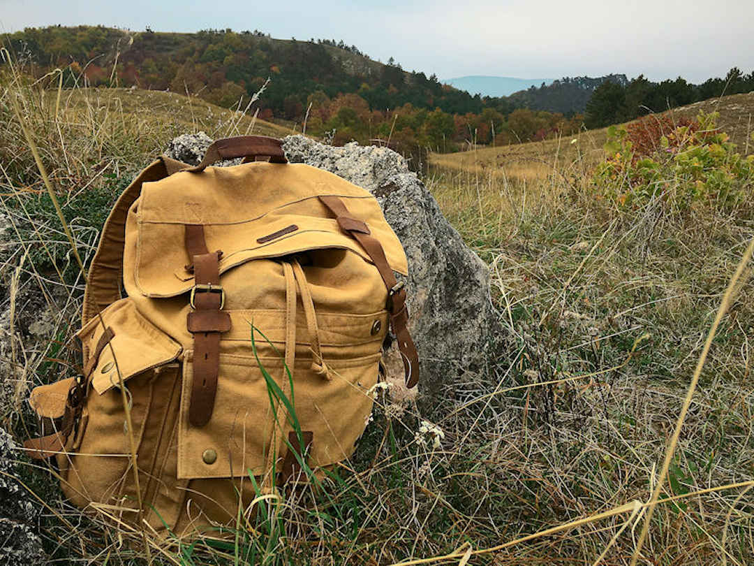 Canvas backpack in field by Adam Hornyak on Unsplash