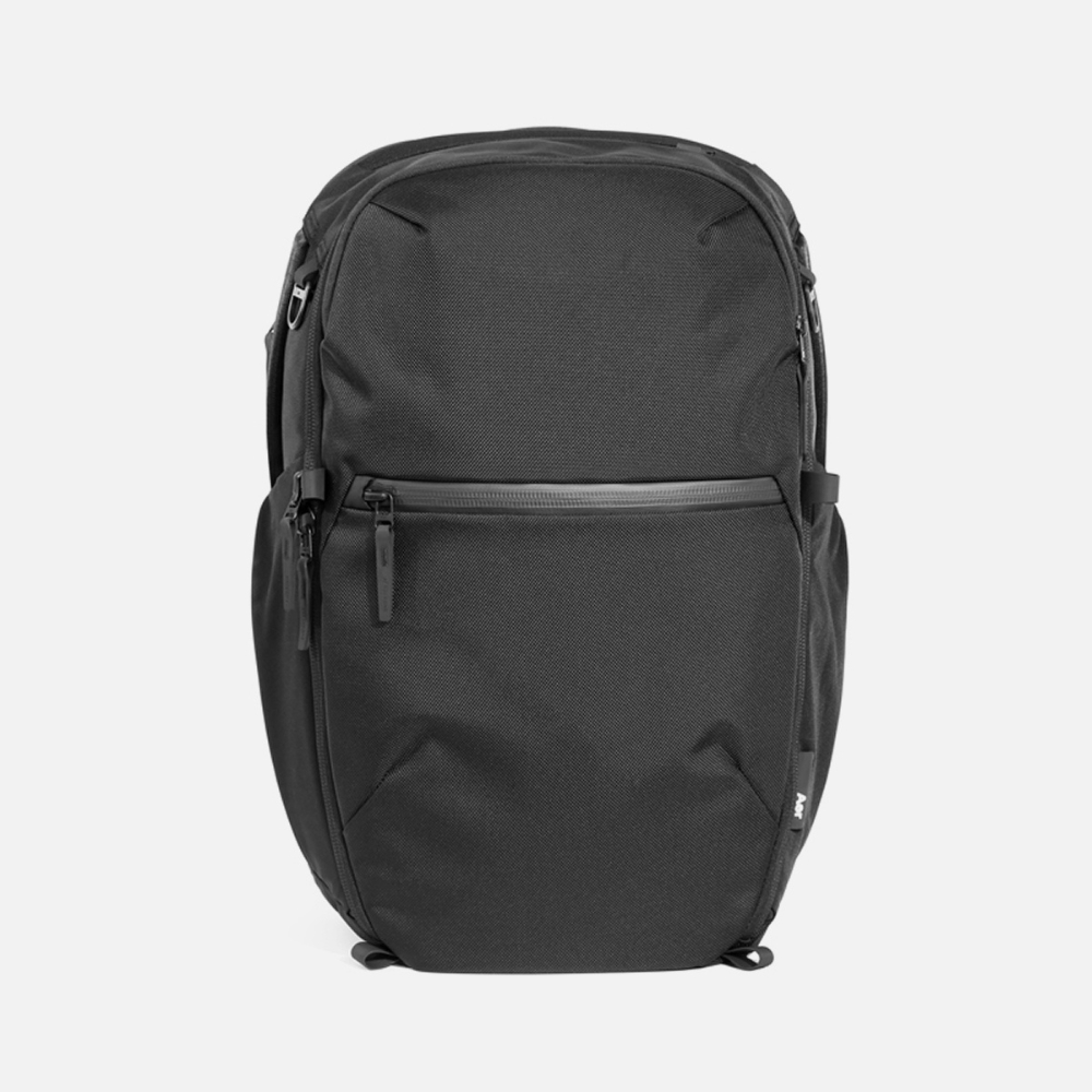 Black minimalist backpack with front zipper pocket