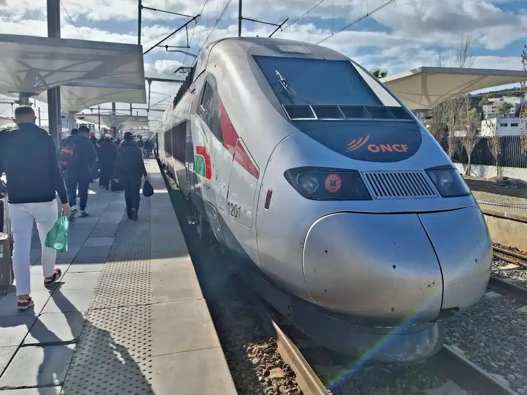 Passengers boarding high-speed ONCF train at station.