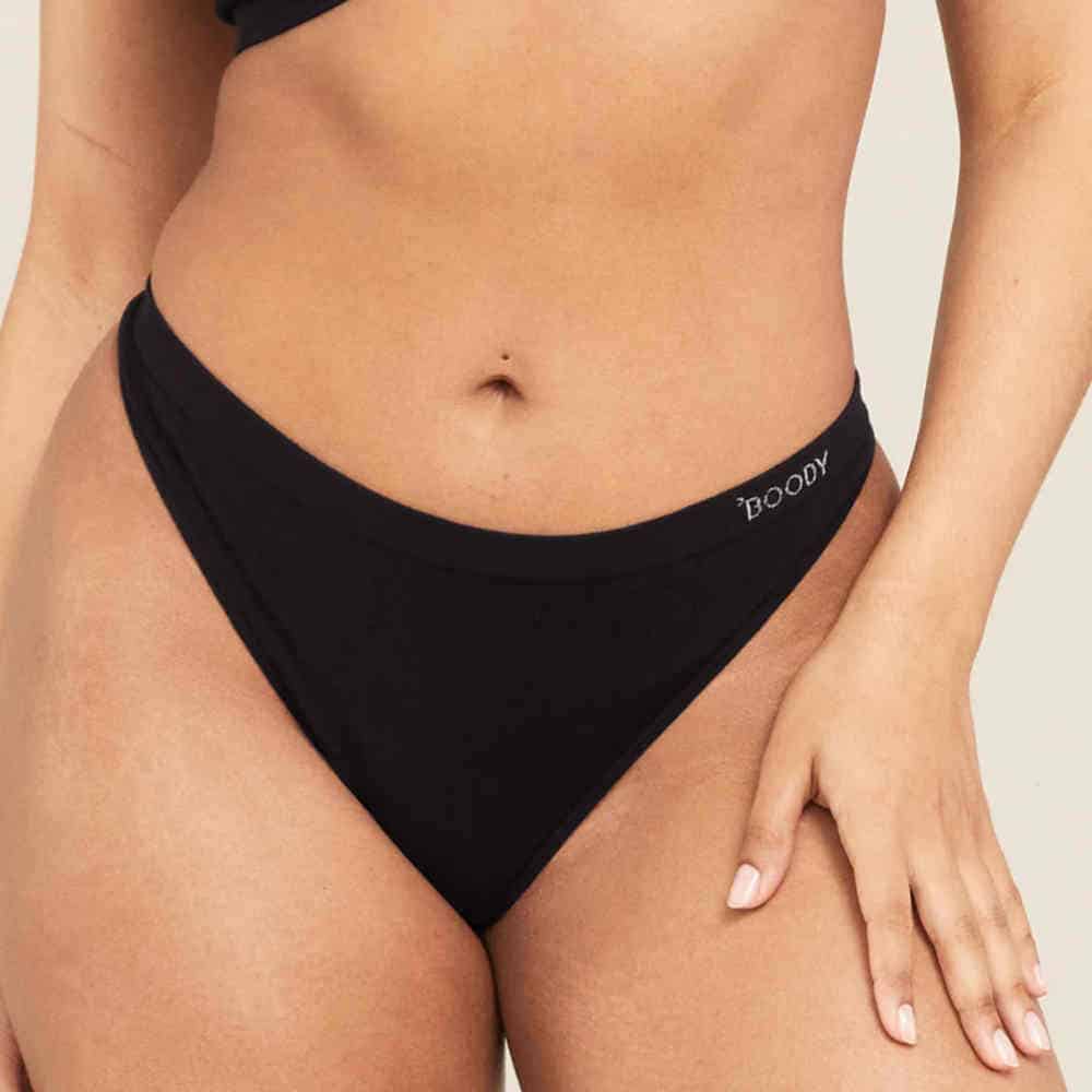 Woman wearing black Boody G-String, showcasing minimalist and sustainable bamboo underwear.