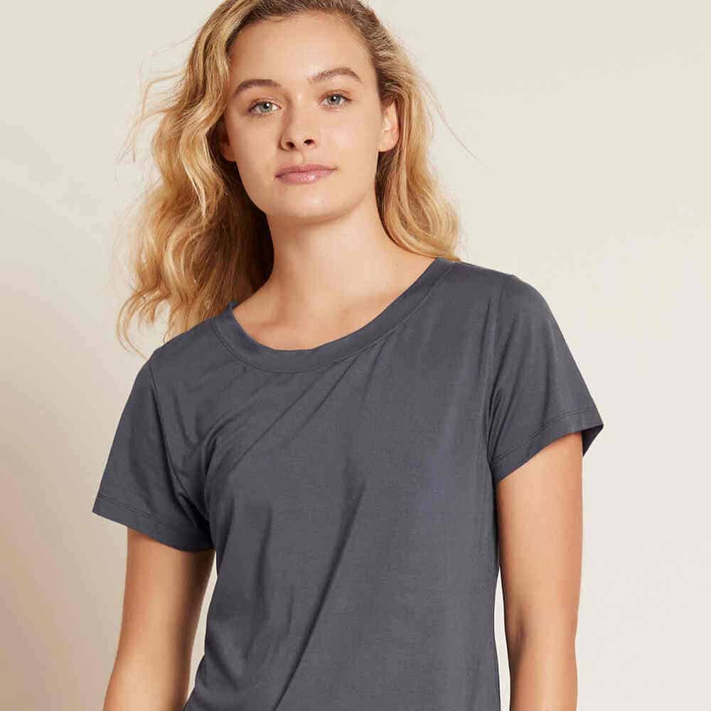 Person wearing a gray t-shirt, neutral background.
