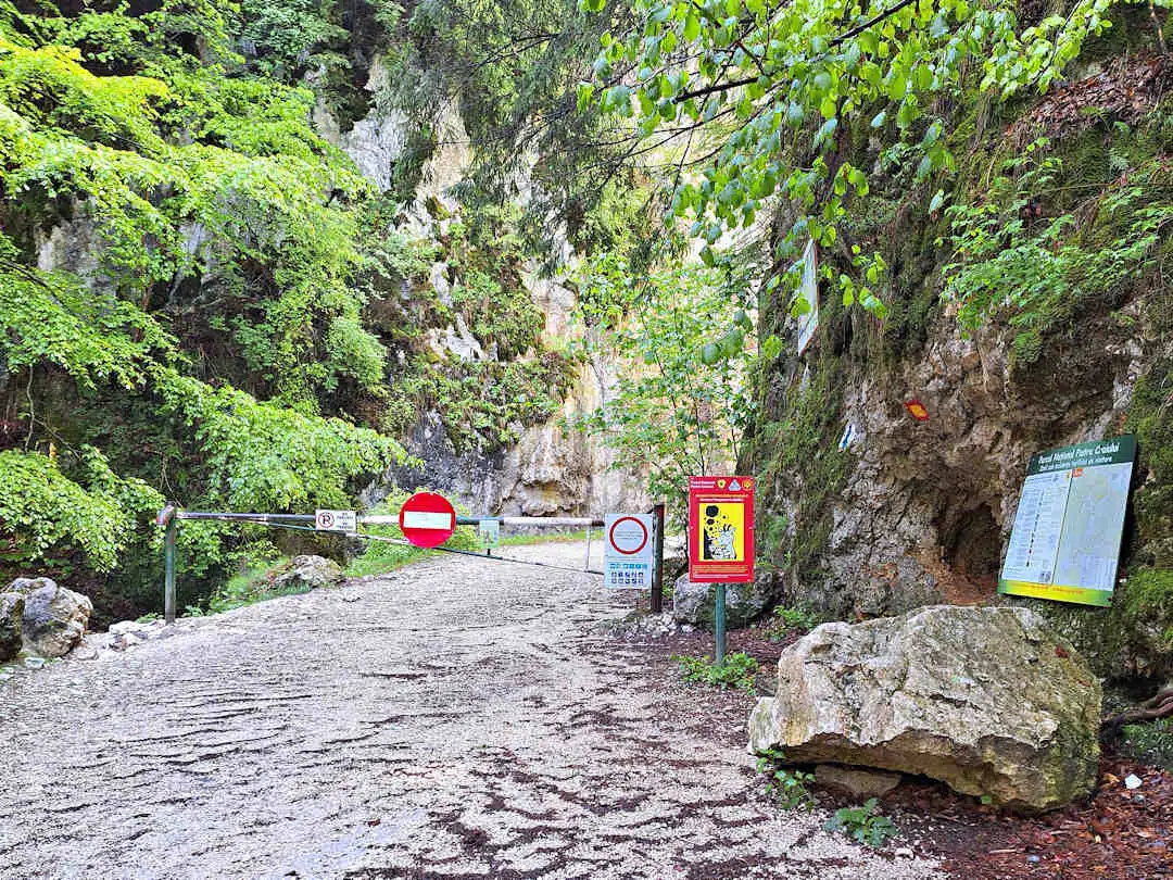 boomgate at zărnești gorge Trailhead with Boom Gate and Hiking Signs at the Start of Zărnești Gorge in Piatra Craiului National Park