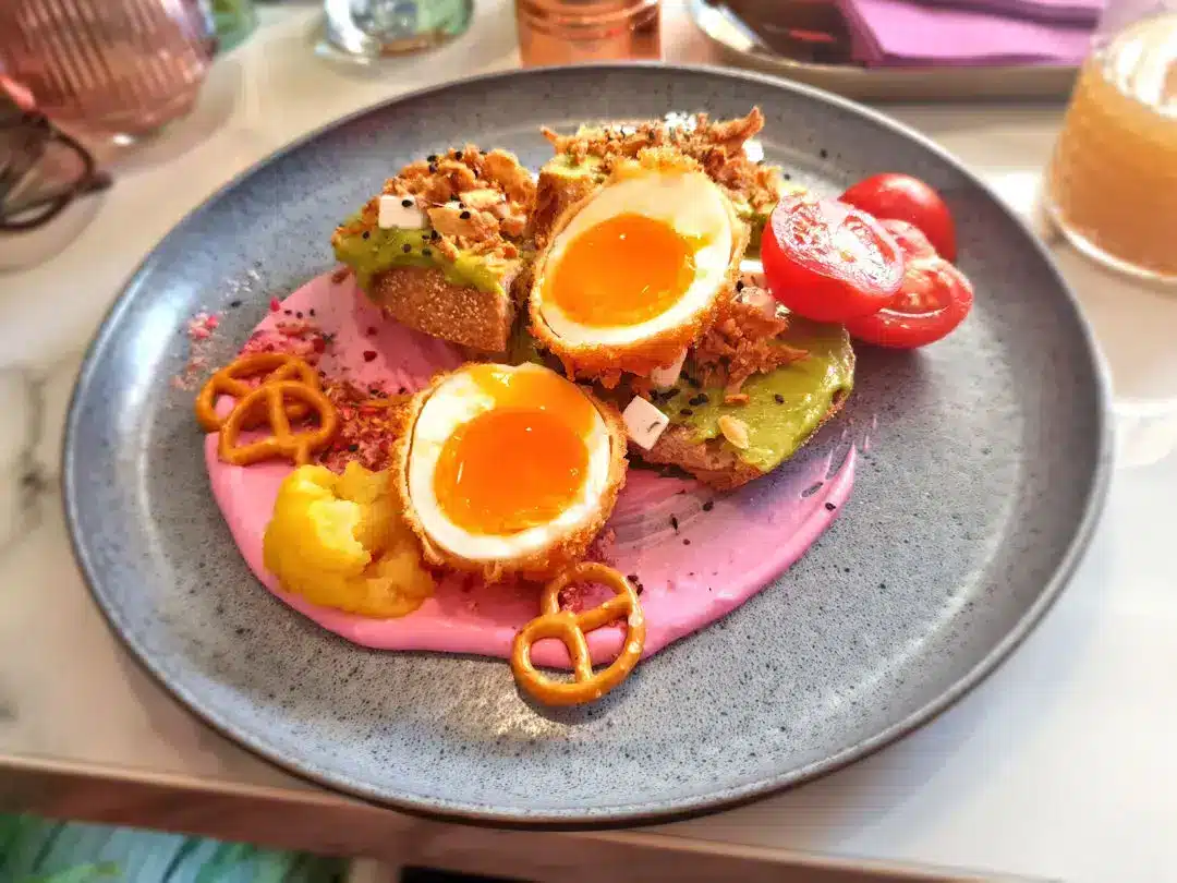 Brunch at Zileat Budapest Gourmet toast with eggs, avocado, tomatoes, and sauces