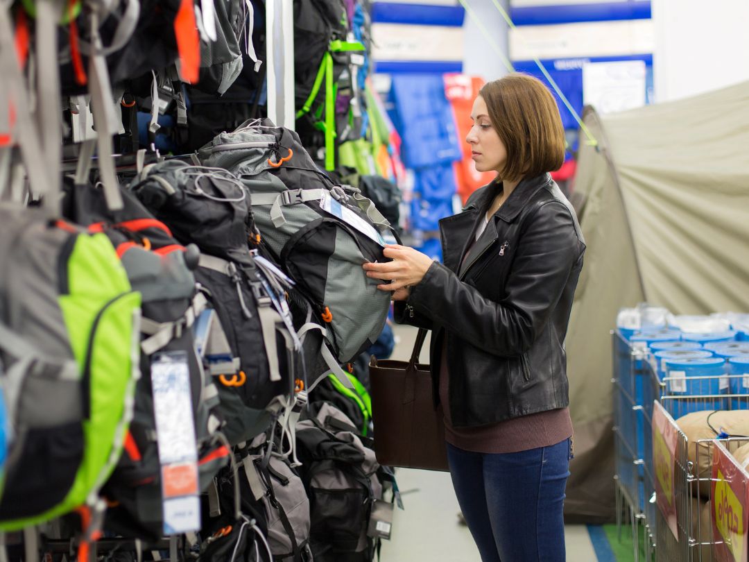 Female shopper looking at backpacks