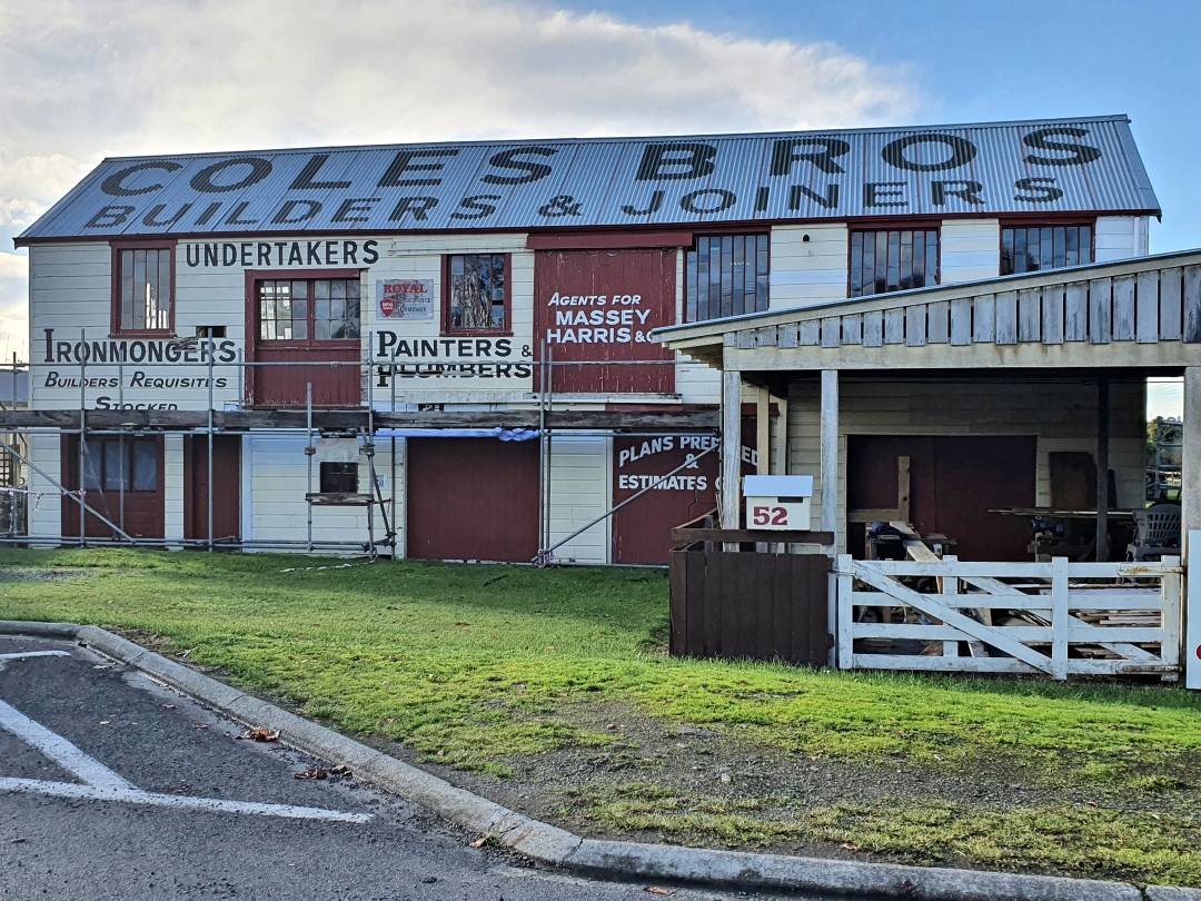 Historic Coles Bros Builders storefront with vintage signage