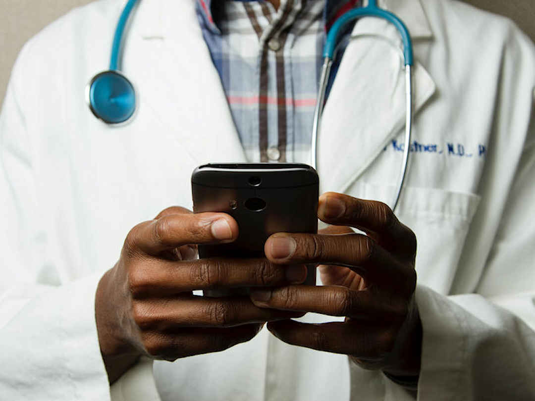 doctor checking smartphone