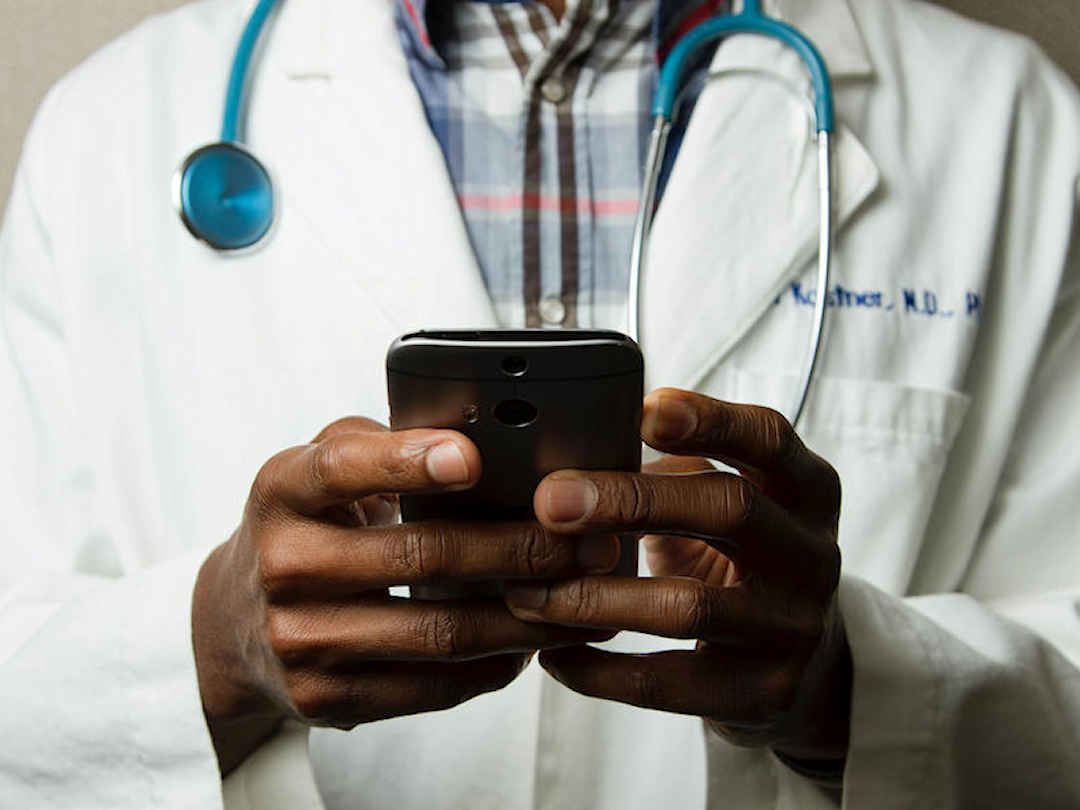 doctor checking smartphone doctor checking smartphone