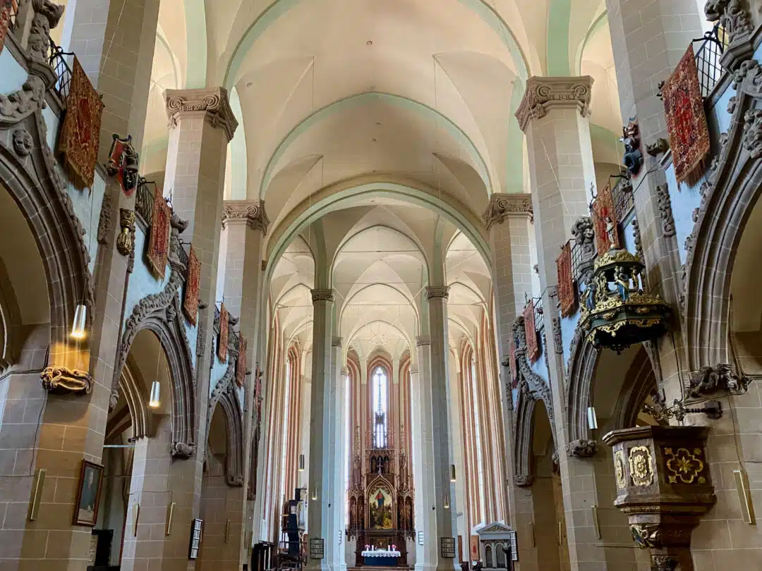 interior black church brașov by josep renalias on wikimedia commons Gothic Interior of the Black Church in Brașov with Vaulted Ceilings and Ottoman Rugs