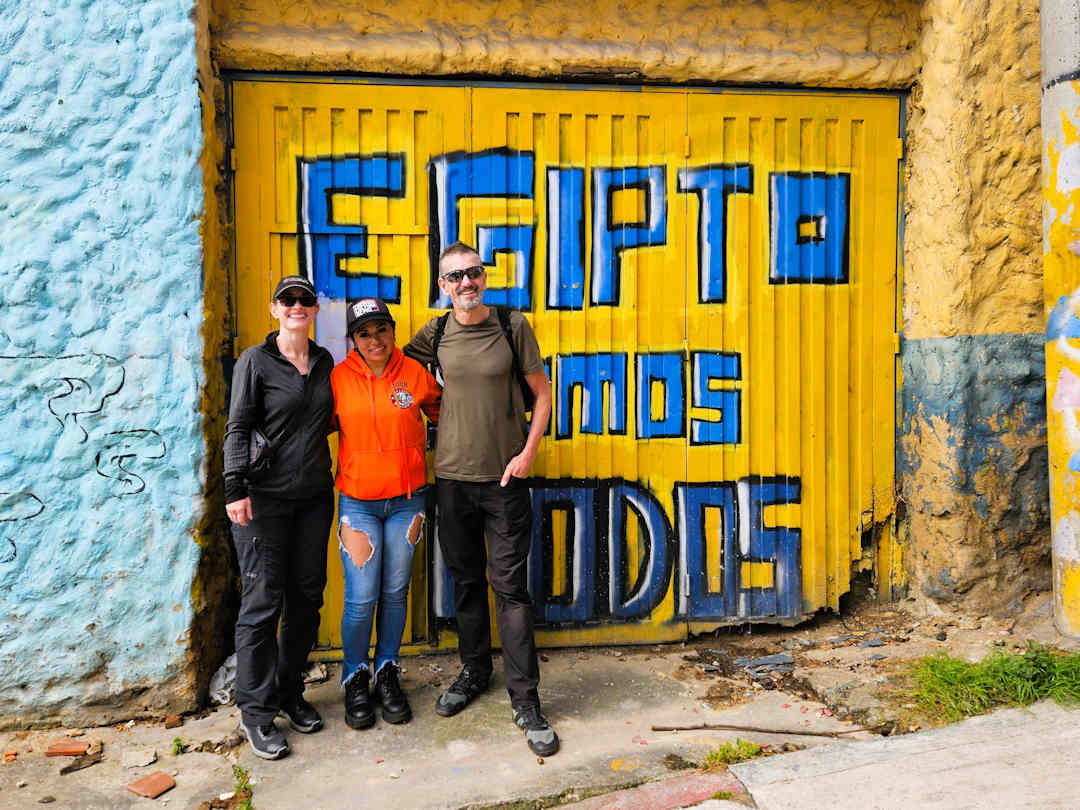 minimalist journeys and viviana from breaking borders Paul and Sandra with Breaking Borders guide in front of the Egipto Somos Todos mural in Barrio Egipto Bogotá