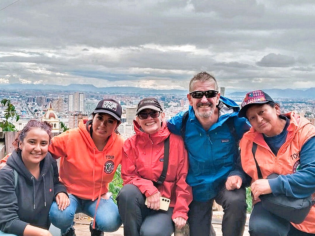 minimalist journeys with impulse travel and breaking borders guides Travellers with Breaking Borders guides at a viewpoint in Barrio Egipto Bogotá during the community walking tour