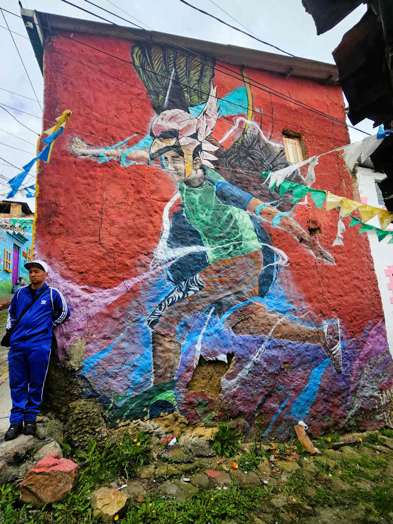 mural of 10 year old boy at barrio egipto Mural of a boy wearing an eagle mask in Barrio Egipto Bogotá, symbolising a violent past remembered on the Breaking Borders Walking Tour