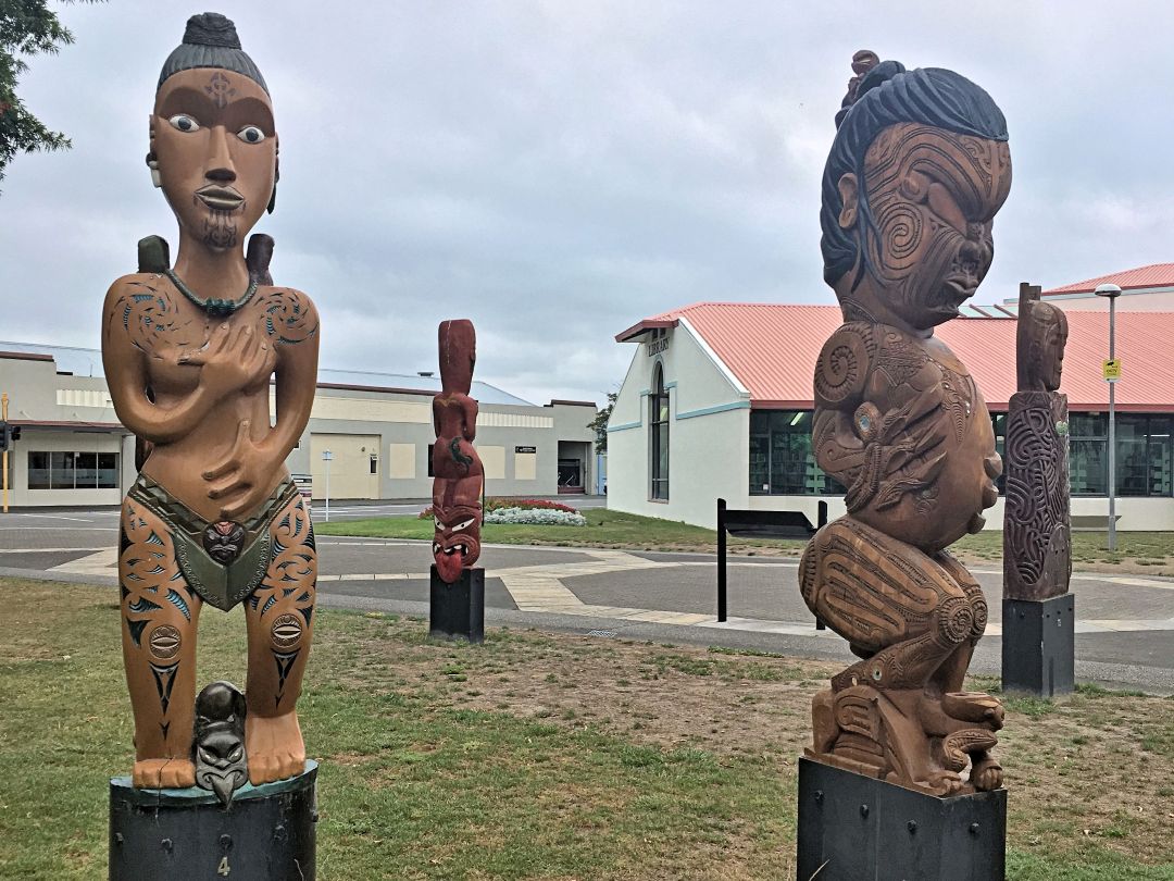 Carved wooden statues in outdoor plaza