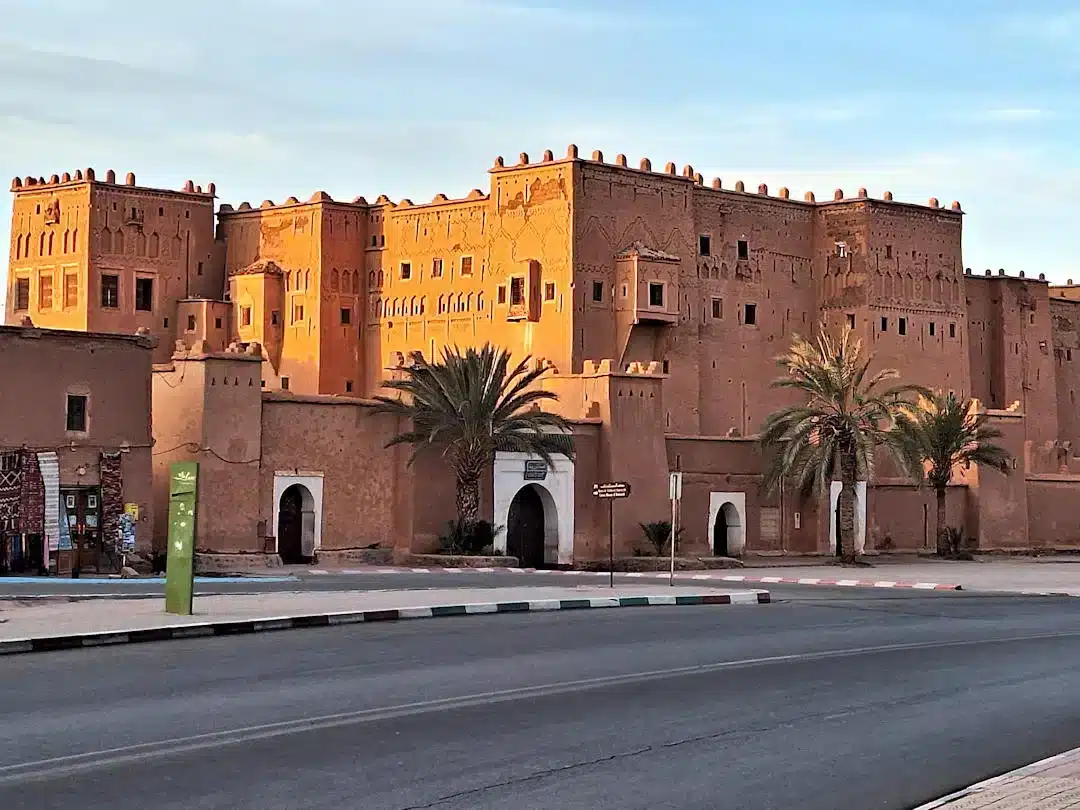 Parking outside Kasbah Taourirt Ouarzazate Taourirt Kasbah at sunset