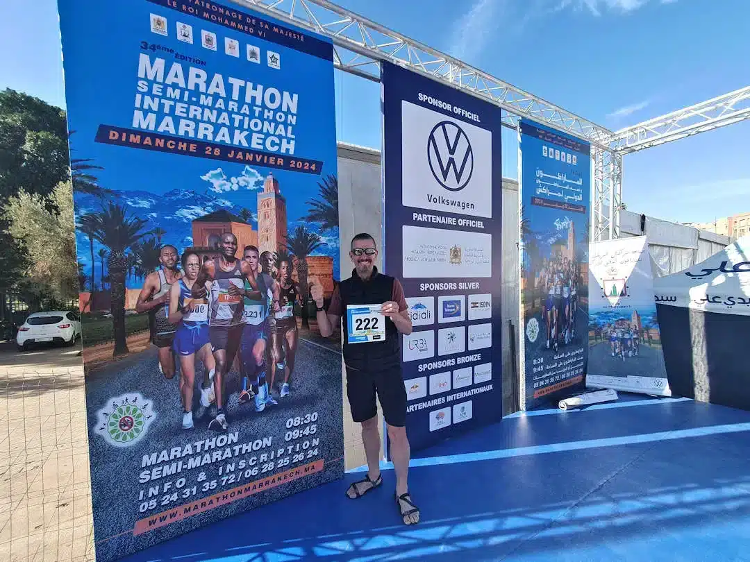 Man posing at international marathon promotional event in Marrakech.