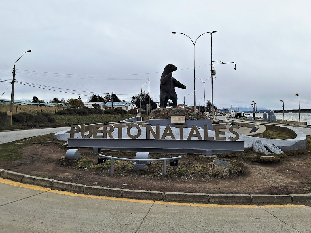 The Puerto Natales welcome sign featuring a large bear sculpture at the town entrance.