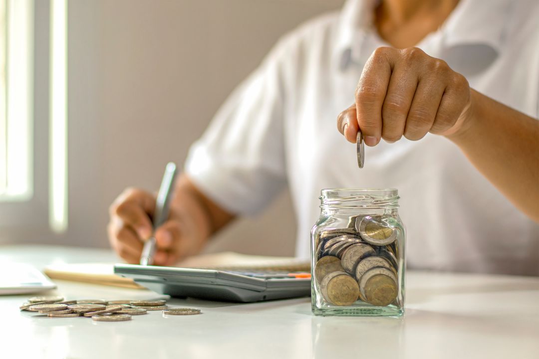 putting coins in jar