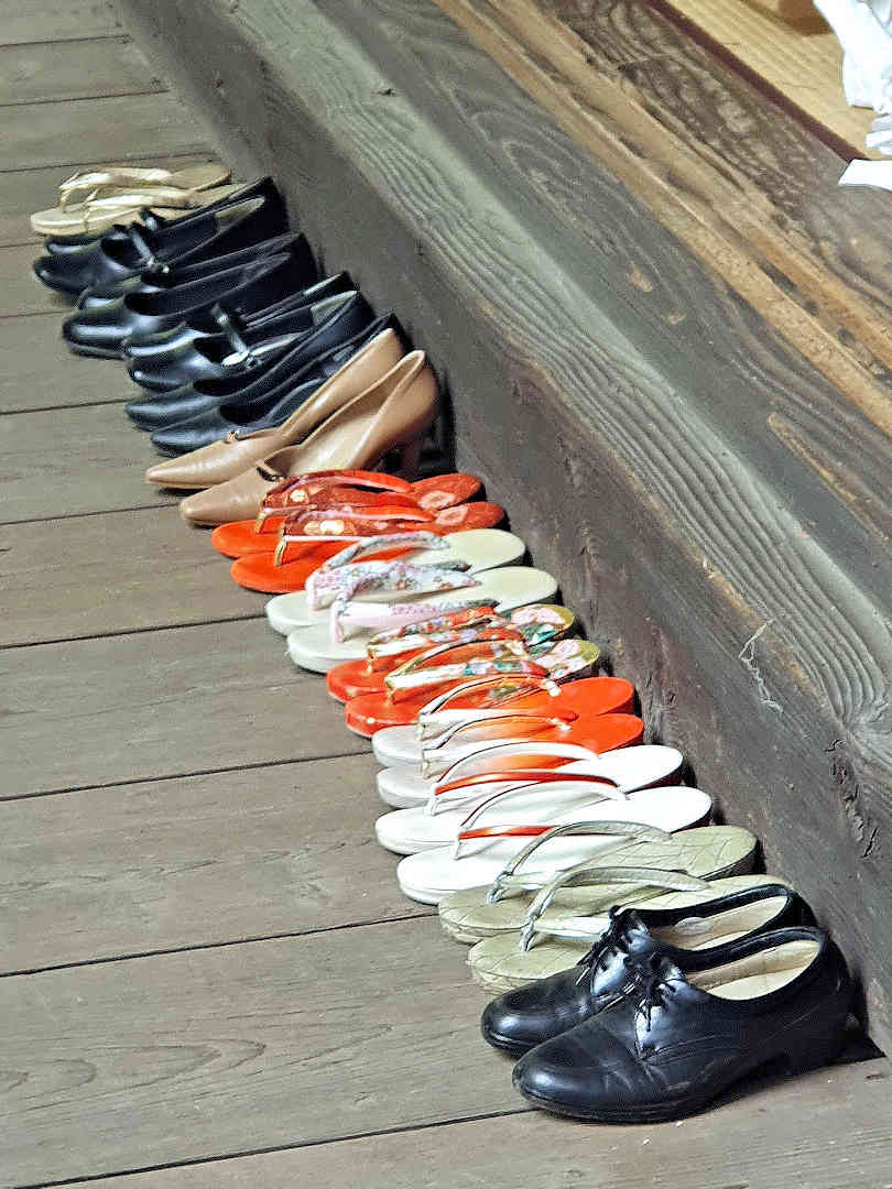 row of shoes outside shrine