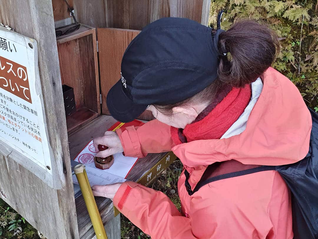 sandra collecting stamp along kumano kodo