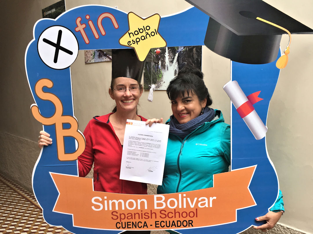 sandra graduating from simon bolivar spanish school in cuenca Sandra and teacher holding a certificate at Simon Bolívar Spanish School in Cuenca, Ecuador using a branded photo frame