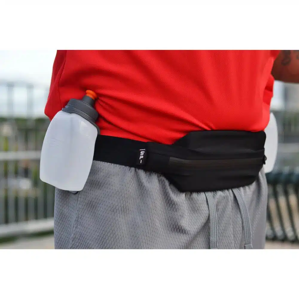 Man running with SPIbelt Distance Pro hydration belt and dual bottles
