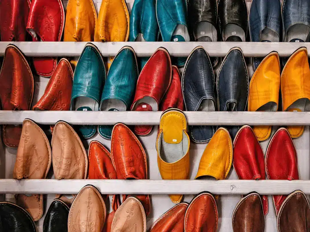 Store shelf full of babouch by Martin Adams on Unsplash Colorful leather shoes displayed on wooden shelves