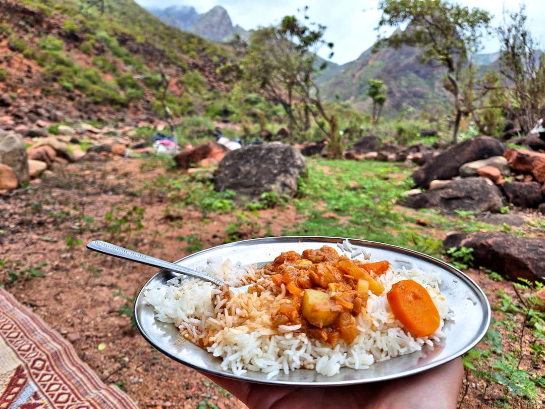 typical lunch during hike Plate of rice and curry outdoors in nature.