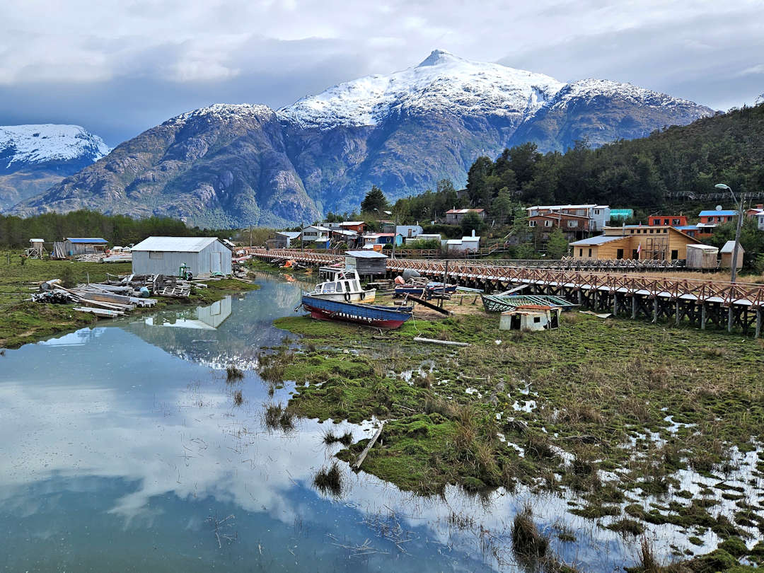 view of caleta tortel and the surrounding mountains from the playa ancha bridge