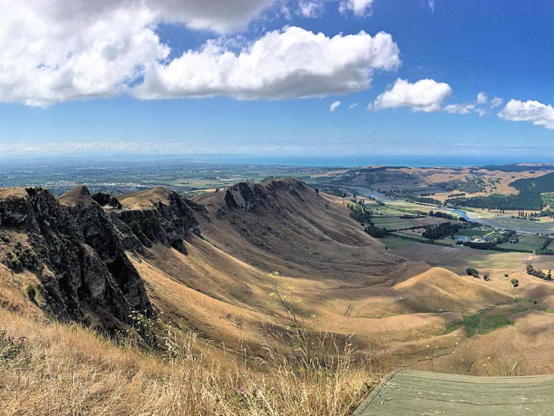 Rocky ridge overlooking golden hills and valley